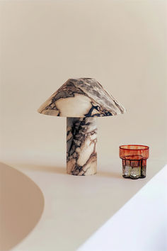 a mushroom shaped object next to a candle holder