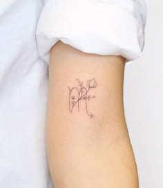 a person with a tattoo on their arm and the word love written in cursive writing