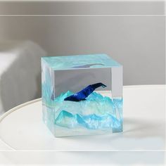 a glass block with an image of a bird in the water on it's surface