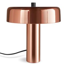 a copper colored table lamp with a black cord attached to the base and a white background