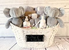 a basket filled with stuffed animals sitting on top of a wooden floor