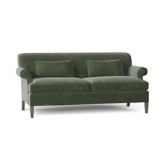 a green couch with two pillows on the back and one arm upholstered to it