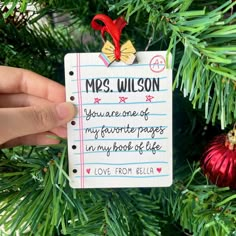 someone is holding up a christmas ornament that reads, mes wilson you are one of my favorite pages in my book of life