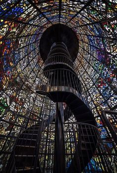 the inside of a large stained glass dome with a birdcage on it's side