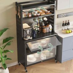 a kitchen with a black cabinet filled with food and drinks next to a potted plant