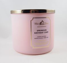 a pink candle that is sitting on a table