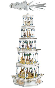 a tall white tower with lots of different items on it's top and bottom