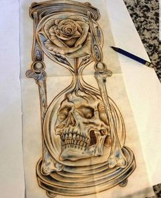 a drawing of a skull in an hourglass with a rose on it's side