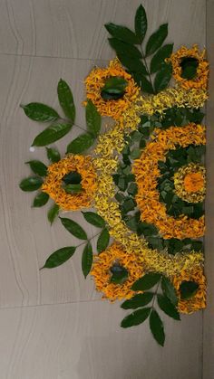 yellow and green flowers are arranged on the floor