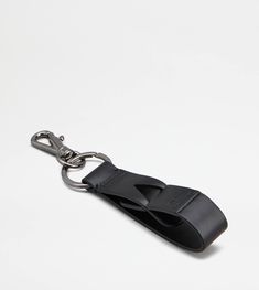 a black leather keychain on a white background