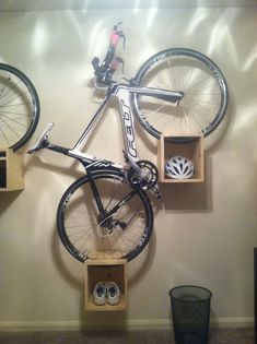 a bicycle mounted to the wall with wooden boxes