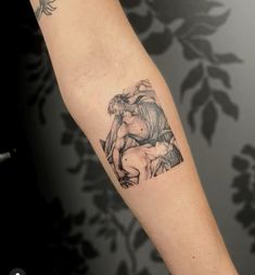 a black and white photo of a man's arm with a tattoo on it