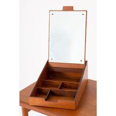 a wooden desk with a mirror and drawers on it