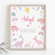 a wooden frame with dinosaurs and rainbows on it, sitting next to a potted plant