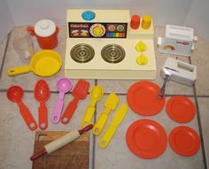 an assortment of kitchen utensils and toys on the floor