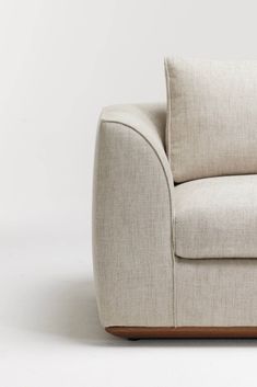 a white couch sitting on top of a wooden table