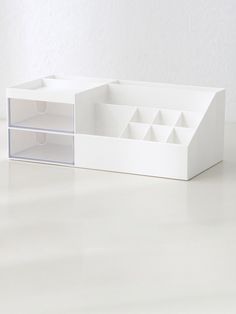 an empty white box with compartments on the inside