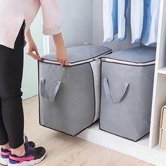 a woman standing next to two storage bins