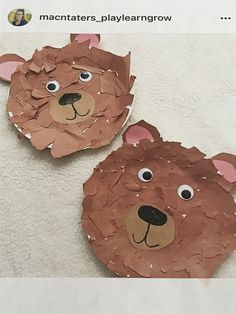 two brown bears made out of paper on top of a white sheet with one bear's head cut out