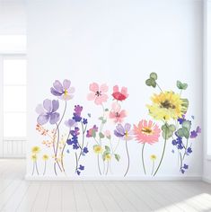 an empty room with flowers painted on the wall