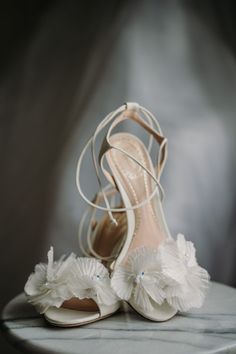 a pair of white shoes sitting on top of a table