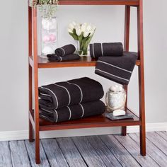 a shelf with towels and flowers on it