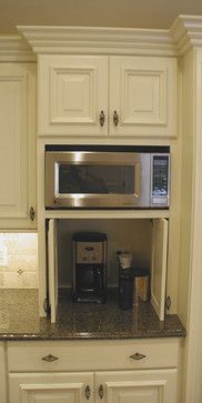 the microwave is built into the cabinet above the coffee maker