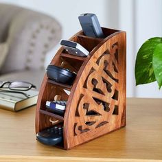 a wooden phone holder with cell phones in it