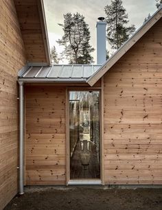 a house with wooden sidings and glass doors on the front door is seen from outside