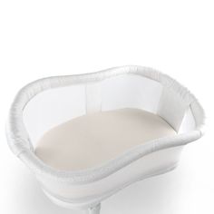 a white baby crib with a cushion on the top and bottom, in front of a white background