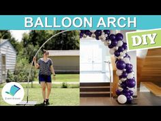 the balloon arch is made with purple and white balloons