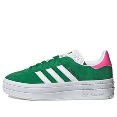 The adidas Originals Gazelle Bold 'Green Lucid Pink' is a modern update to the legendary suede training shoe of the 70s. With a thick sole and raised heel, this bold sneaker is designed to stand out. The soft suede upper and three-stripe detailing give it a sporty look, while the gold "gazelle" logo adds a classic touch. Perfect for everyday wear, this sneaker is also great for light workouts and casual sports. The 'Green Lucid Pink' colorway is inspired by the iconic Gazelle series, making it a timeless addition to any wardrobe. Pink And Green Adidas, Light Workouts, Campus Adidas, Adidas Gazelle Bold, Gazelle Adidas, Light Grey Leggings, Adidas Outfit Shoes, Gazelle Bold, Green Platform