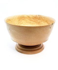 a wooden bowl sitting on top of a table