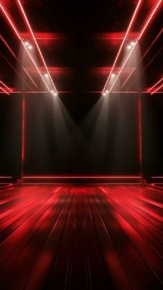 an empty room with red lights and wooden floors