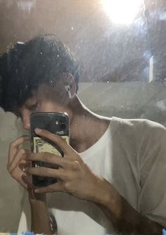 a person taking a selfie in front of a mirror