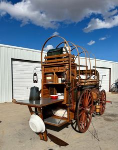 an old wooden cart sitting in front of a building