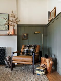 a living room filled with furniture and a clock on the wall above it's fireplace