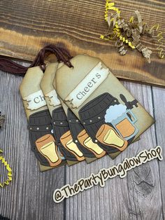 three pairs of oven mitts sitting on top of a wooden table next to dried flowers