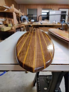 a wooden surfboard sitting on top of a table