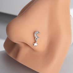 an earring with a crescent and star on it sitting on top of a mannequin's head