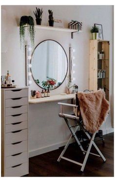 a mirror sitting on top of a dresser next to a white desk with drawers and a chair