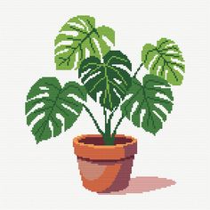 a cross stitch pattern of a potted plant with green leaves on it's side