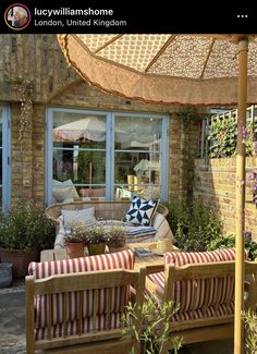 an outdoor patio area with furniture and umbrella