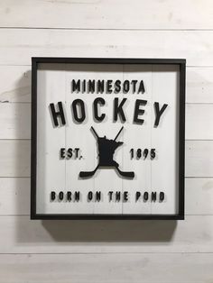 a sign that says minnesota hockey on the wall