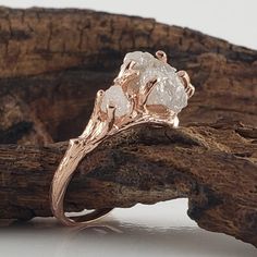 a close up of a ring on top of a piece of wood