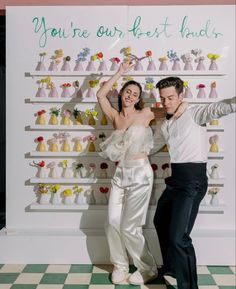 two people standing next to each other in front of a sign that says you're our best friend