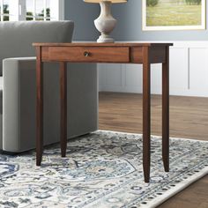 a living room scene with focus on the end table and sofa in the foreground