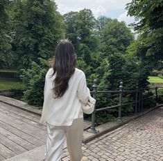 a woman in white is walking down some steps