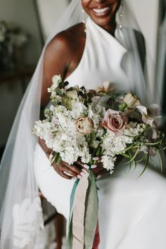 a woman in a wedding dress holding a bouquet