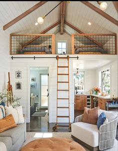 a living room filled with furniture and a ladder